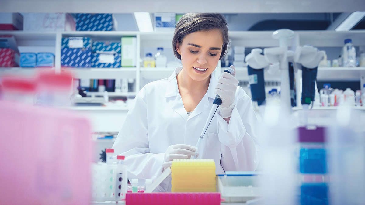 Female scientist in laboratory pipetting